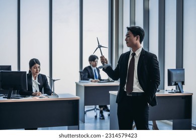 Renewable energy analyst team conduct research using data and statistics to brainstorm, assess potential sites for wind farm installations and operation, Exploring company's investment opportunities. - Powered by Shutterstock