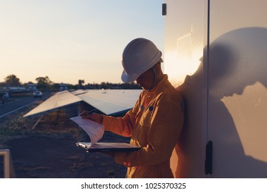 Renewable Energy And Solar Power Concept, Worker Or Electrical Engineers Are Checking, Installing Or Cleaning Photovoltaic Plant In Solar Power Station Alternative Energy From Nature