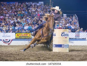 RENO , USA - JUNE 30 : Cowgirl Participant in a Barrel racing competition in Reno Rodeo a Professional Rodeo held in Reno Nevada , USA on June 30 2013 