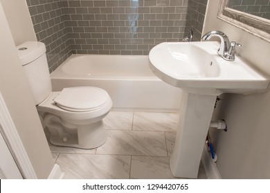 Renovated Bathroom With Toilet, Shower Tub, And Sink.