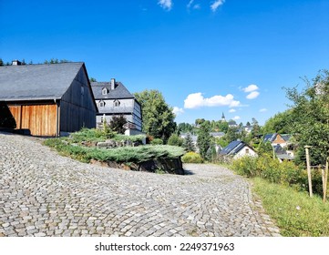 renovated farm house with barn in a village  - Shutterstock ID 2249371963