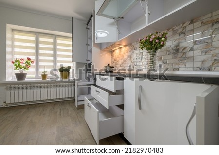 Renovated Interior for modern trendy white kitchen with doors open
