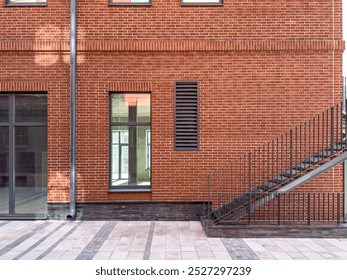 renovated old red brick industrial building. corner of building with outdoor metal stairs. - Powered by Shutterstock