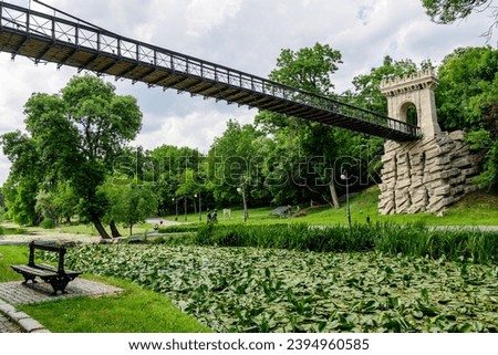 Renovated suspended metallic bridge in Nicolae Romaescu park from Craiova in Dolj county, Romania, in a beautiful sunny spring day