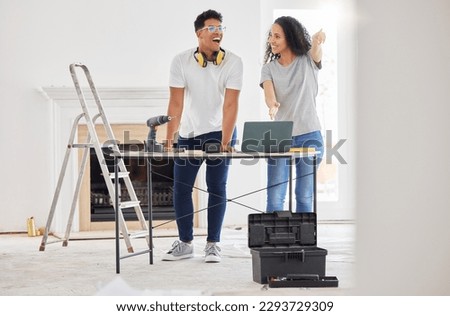 Renovating a house is a no brainer for people who like a challenge. Shot of a young couple using a laptop while busy renovating a house.