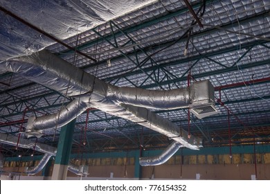 Renovation Office HVAC Duct Cleaning, Ventilation Pipes In Silver Insulation Material Hanging From The Ceiling Inside New Building.