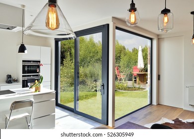 Renovation on a Modern luxury kitchen  with sliding door and view on a lush garden