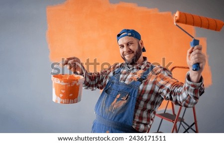 Renovation, redecoration and repair concept. Funny bearded man with painting roller and bucket indoors. [[stock_photo]] © 