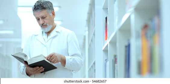 Renowned Scientist/doctor In A Library Of Research Center/hospital - Browsing A Book