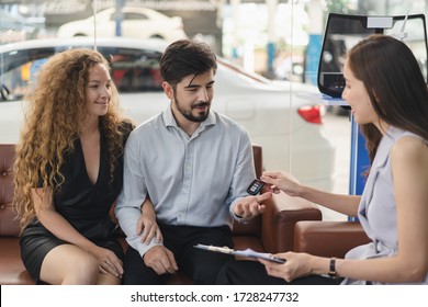 Rent A Car Business Concept. Agent Rental Vehicles Company Giving A Car Key To Client / Customer In Office After Explain Agreement Document And Term Of Used To Lender.