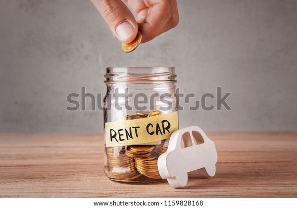 Rent car. Glass jar\
with coins and an inscription of rent car and symbol of  car. Man\
holds coin in his hand