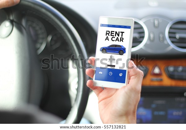 rent concept:\
driver holding smartphone with rent a car website on screen. All\
screen graphics are made\
up.