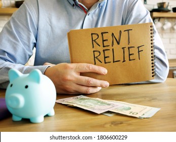 Rent Relief. A Man At Home Holds A Handwritten Lettering.