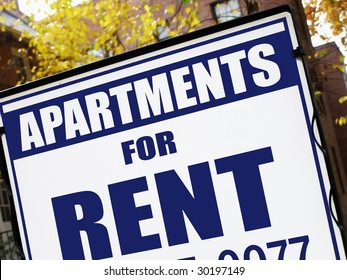 For Rent Sign In Front Of Apartment Building.