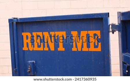 For Rent Sign on Door of Dirty Metal Dumpster.