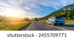 rental car in spain mountain landscape road at sunset. wide angle panorama shot