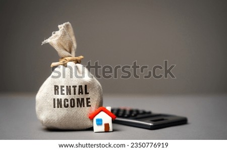 Rental income concept. The concept of profit from the rental of real estate, apartments or houses. Landlord income from housing. Money bag, miniature house and calculator