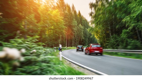 Rental Small Car In European Mountain Landscape Road At Sunset - Motion Blur Effect