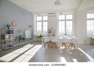 Rental White Meeting Room. Workplace For Business People. Light Modern Office Space Interior. No People. Cozy Office Room With Big Table, Modern Chairs, Flipboard And Large Windows