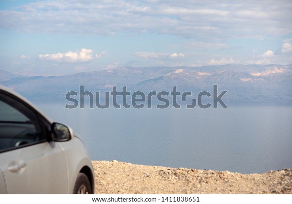 rented car placed over a cliff over the dead sea\
in israel