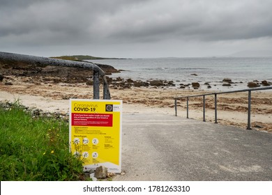 Renvyle Beach, Ireland - 07/14/2020: HSE COVID 19 Information Poster At The Entrance To The Beach, Dark Moody Grey Clouds. Nobody.