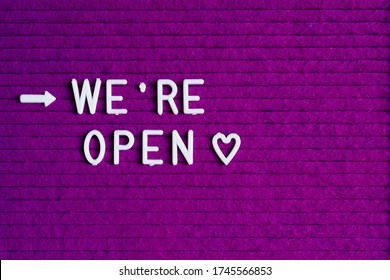 # Reopening Plan Text On Purple Letter Board Near The Notebook. Business Concept. Service, Restaurant, Shop And Cafe Re-opening. Reopening Of The Place After The Quarantine Due To Covid-19. We're Open