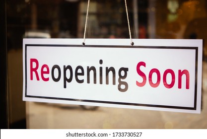 Reopening Soon Signage borad infront of Businesses or Restaurant door after covid-19 or coronavirus outbreak - Concept of back to business after pandemic.