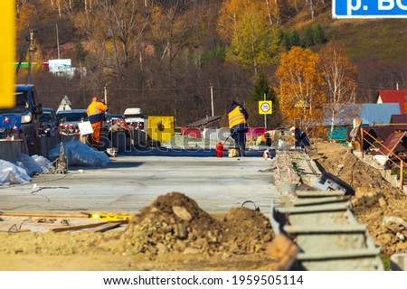 repair of an automobile bridge across the Bolshoi Inzer river on the Beloretsk Ufa highway on a sunny autumn day.
