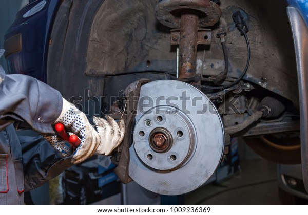 Repair of brake\
pads on the car. Brake\
repair