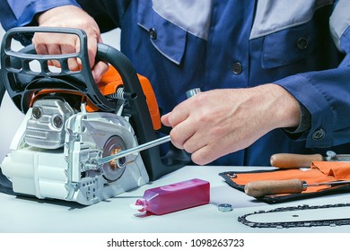 Repair Of Chainsaws,gasoline Tools. Man Repairing Chainsaw.