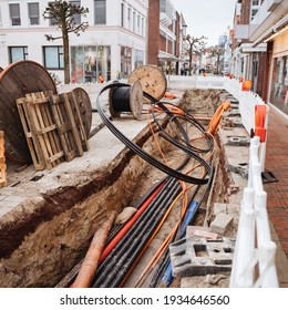 Repair Of Communications. Water Supply, Sewerage Electrician. Repair Works. Excavated Road In The City. Underground Pipes And Cables. German Old City