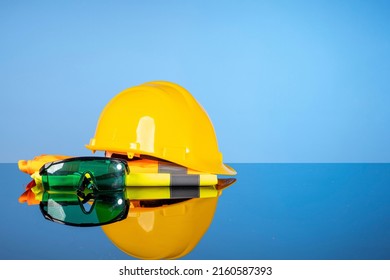 Repair and construction tools, safety helmet, vest and green goggles. Do it yourself concept, sale of goods for renovation and construction, home renovation services.