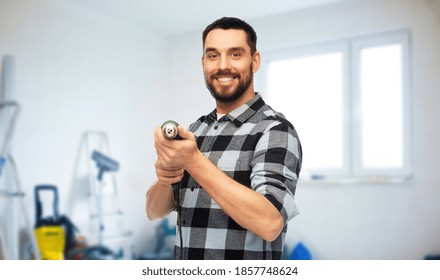 Repair, Construction And Work Concept - Happy Smiling Man, Worker Or Builder With Drill Over Room With Building Equipment Background