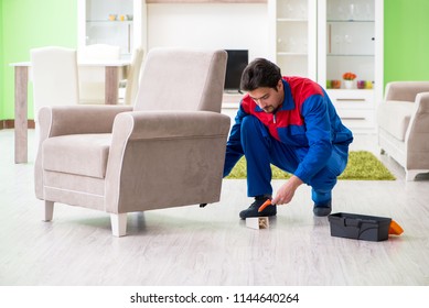 Repair Contractor Repairing Broken Furniture At Home