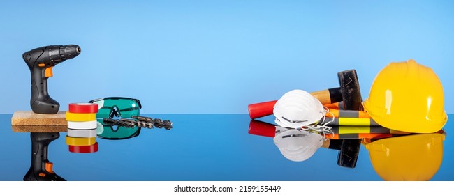 Repair Hand Tools, Sledgehammer, Drill, Safety Helmet, Drills, Goggles, Electrical Tape. The Concept Of Construction And Repair Work, Do It Yourself, Apartment Renovation Services.