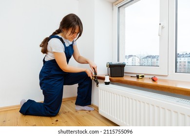 Repair Heating Radiator Close-up. Woman Repairing Radiator With Wrench. Removing Air From The Radiator