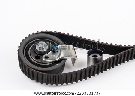 Repair kit: Timing belt with rollers, Tensioner pulley, Deflection pulley, Two rollers, Water pump and bolts on white background. Automobile spare part