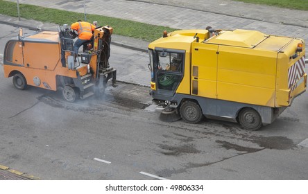 Repair Machines Fixing A Pothole In A Road Caused By Frost