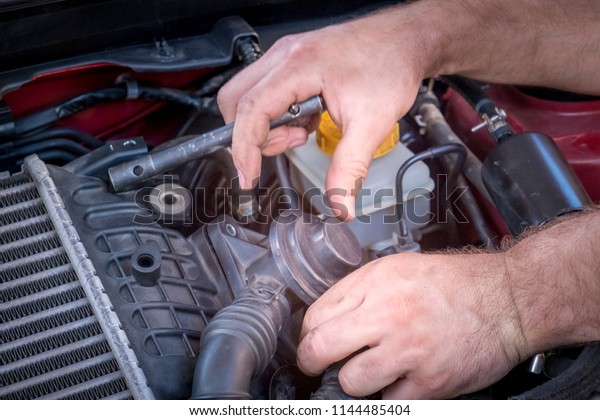 repair and maintenance of the car, men\'s hands\
hold technical car engine\
service