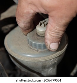 Repair Man Hand Unscrews The Power Steering Fluid Tank, PSF Level Check Under Hood Of The Old Car - Vehicle Maintenance Service