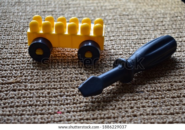 Repair material beside yellow toy car. vehicle\
repair concept.\
