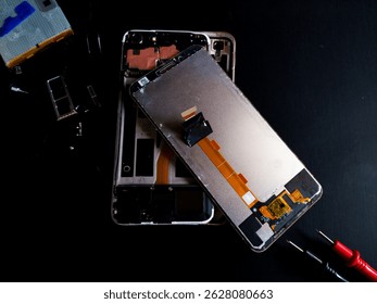 repair of a mobile phone on black background
