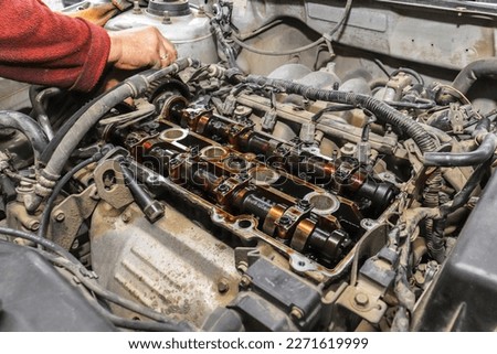 Repair of an old car engine. Replacement of a torn timing belt.