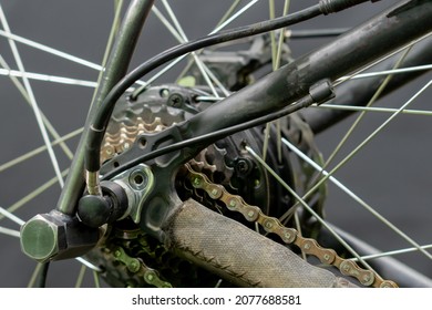 Repair Of An Old Electric Bike. Dirty And Old Bicycle Chain Covered With Rust Close-up. Professional Workshop