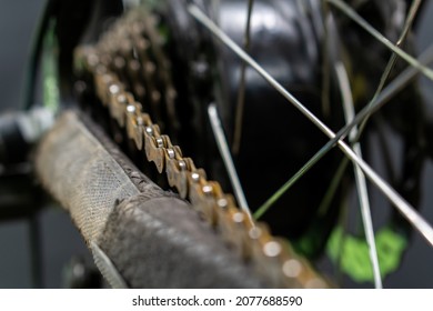 Repair Of An Old Electric Bike. Dirty And Old Bicycle Chain Covered With Rust Close-up. Professional Workshop