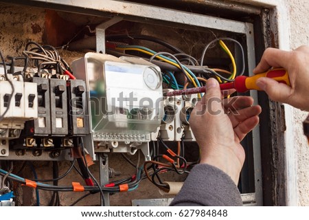 Repair of old electrical switchgear. An electrician replaces old electrical wiring devices