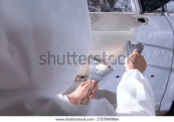 Repair\
and painting car mechanic.worker painting a\
car