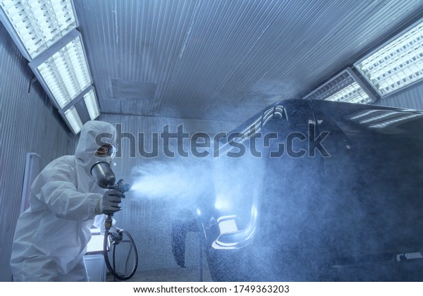 Repair\
and painting car mechanic.worker painting a\
car