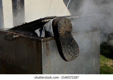 Repair Piping With Hot Water Steam In Hatch Of Device. Only Shoes And Feet Look Out Of Tank. Smoke Rolls In Winds Which Rolls Fog, Dust. Stainless Steel Kitchen Equipment Washes Inside Men, Film, Army