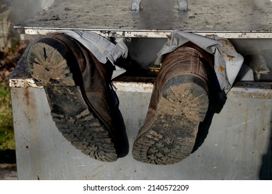 Repair Piping With Hot Water Steam In Hatch Of Device. Only Shoes And Feet Look Out Of Tank. Smoke Rolls In Winds Which Rolls Fog, Dust. Stainless Steel Kitchen Equipment Washes Inside Men, Film, Army